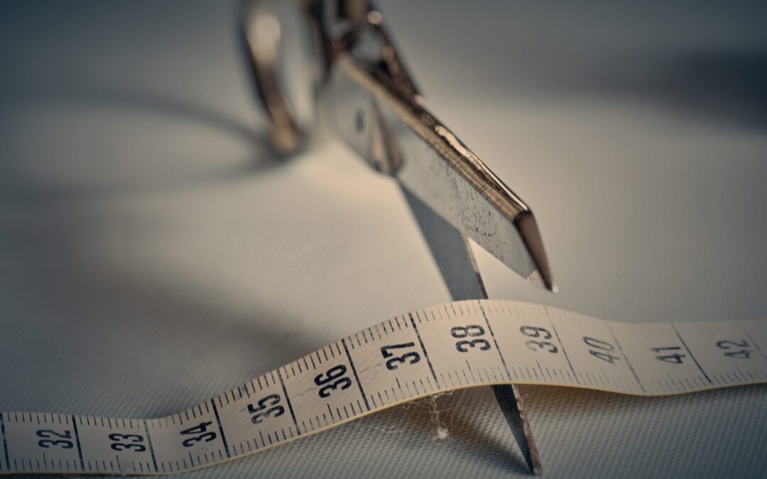 A tape measure being cut with scissors to represent the Hypno Weight Loss Jab as an alternative to restrictive dieting