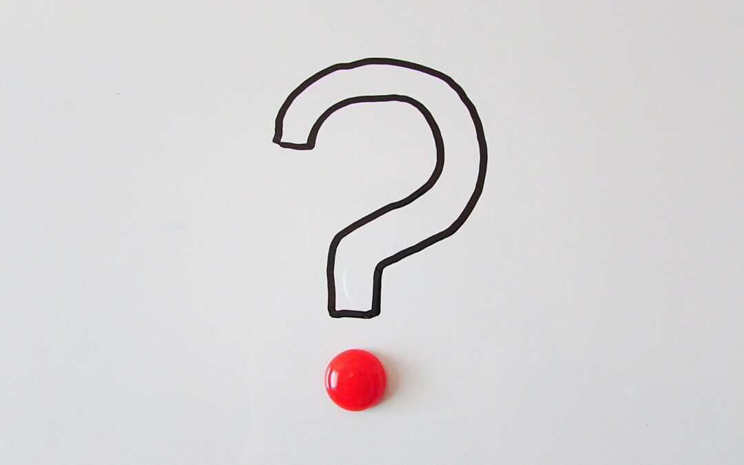 A large, black outline of a question mark on a whiteboard with a single red magnet at the base, illustrating common questions about what is hypnosis and the trance state.